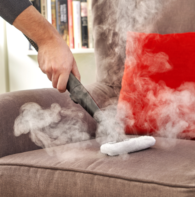 a steam cleaner on a sofa