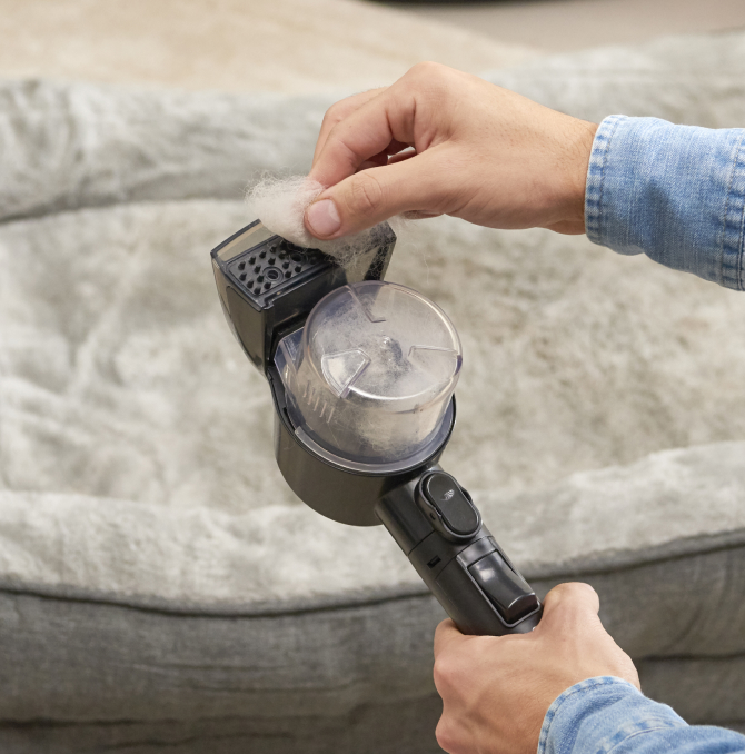 a guy cleaning the nozzle of a steam cleaner