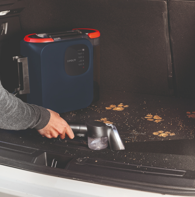 a persona cleaning the car storage