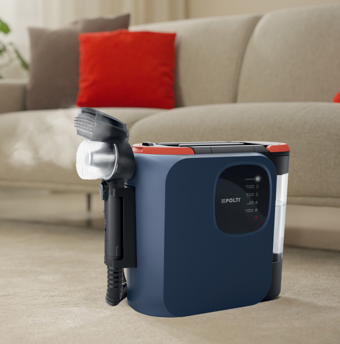 Polti StainOver spot cleaner near a sofa